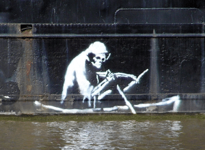 Banksy's "Death Boat" painted on the side of a hull.