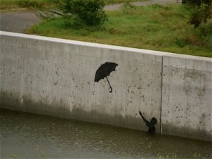 Banksy's "Umbrella Boy" in the Gustav flood waters.
