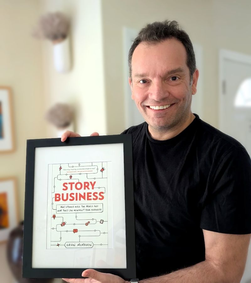 Gavin McMahon, author of “Story Business,” holding his book about narrative governance and brand storytelling for business leaders